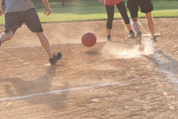 adults playing kickball in a public park league